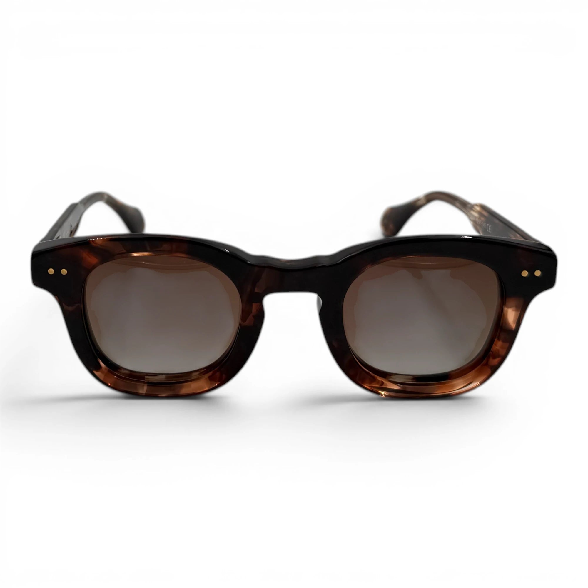 Sunglasses with tortoiseshell frame and dark lenses on a white background