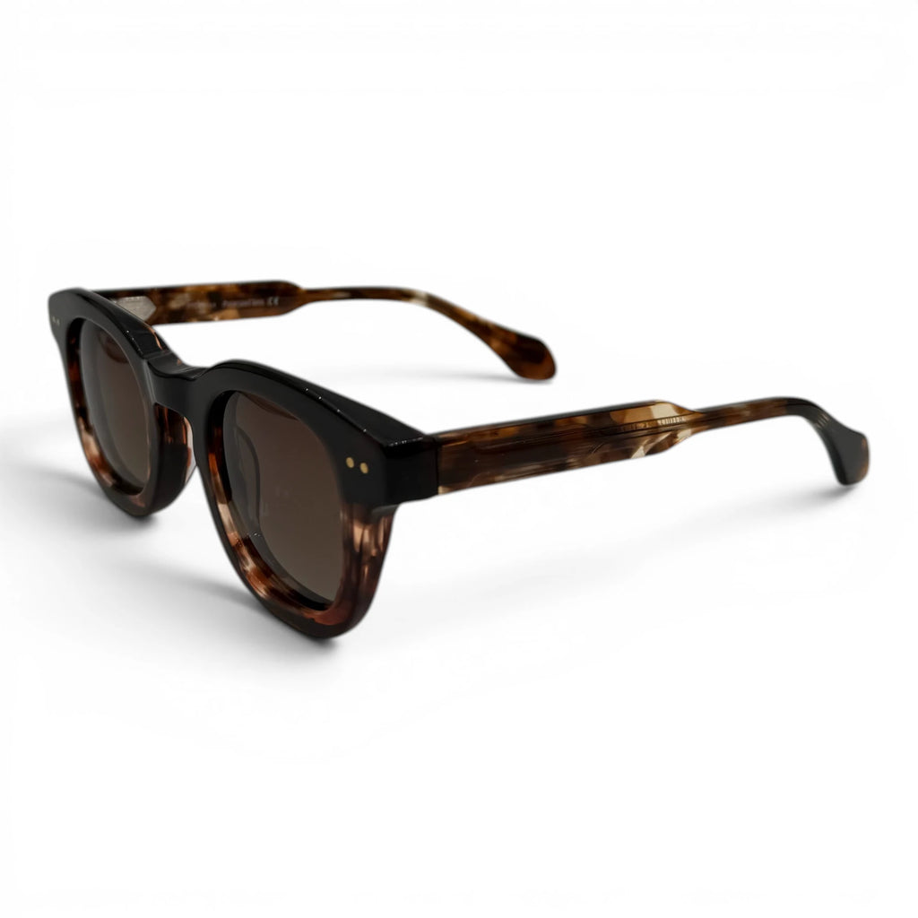 Sunglasses with tortoiseshell frame and dark lenses on a white background