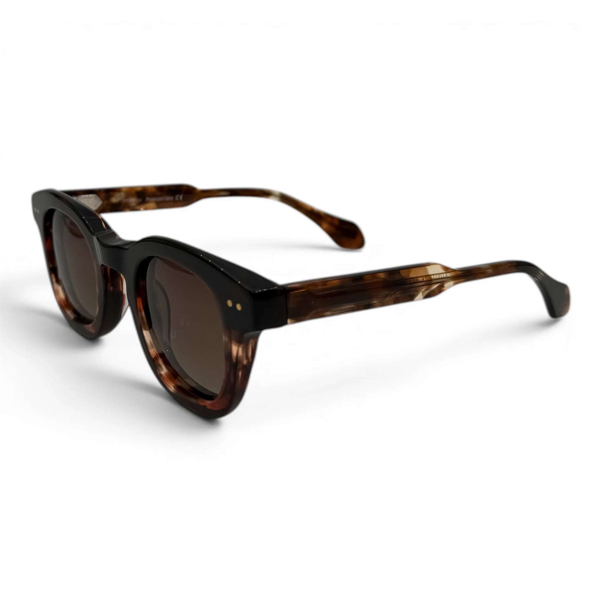 Sunglasses with tortoiseshell frame and dark lenses on a white background