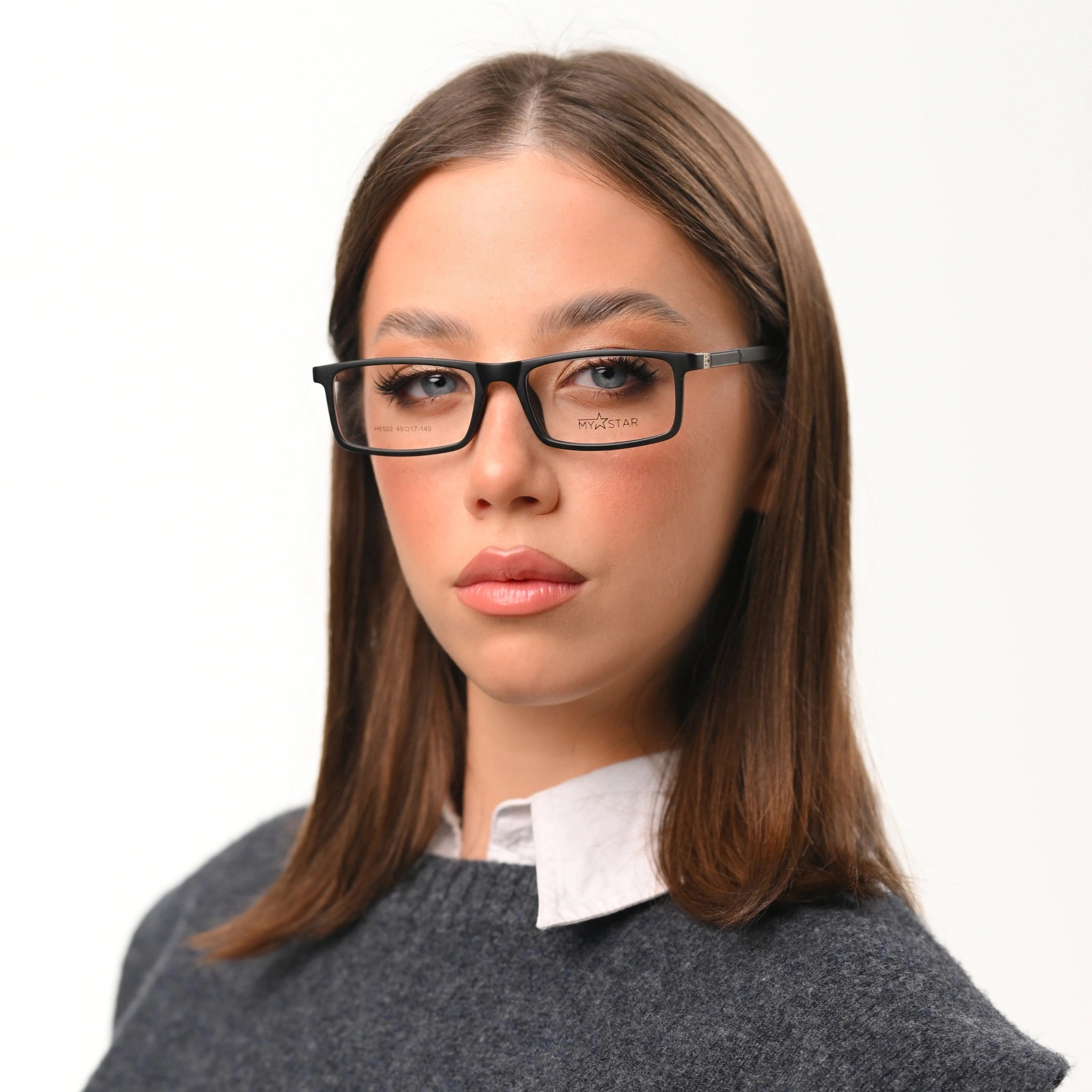 Woman wearing glasses with a plain background