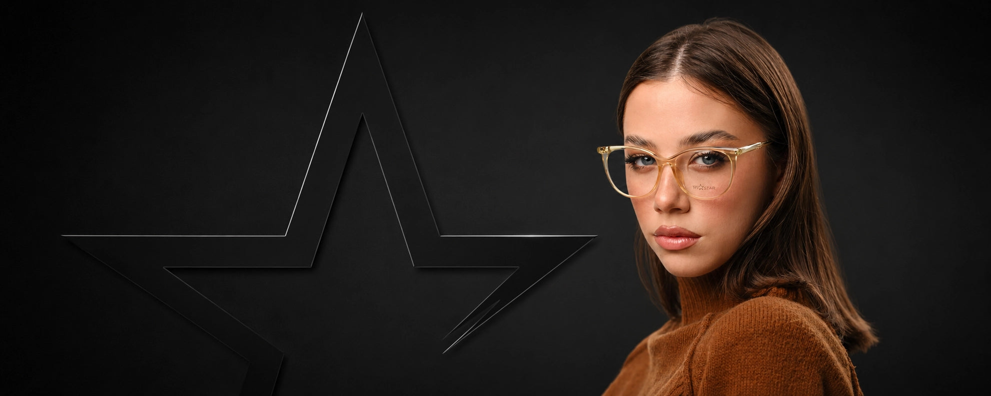 A woman with long brown hair wearing thin gold metal cat-eye glasses, shown against a dark background with a large black star graphic.